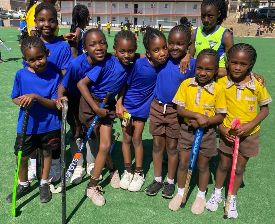 Young hockey players posing together on the field