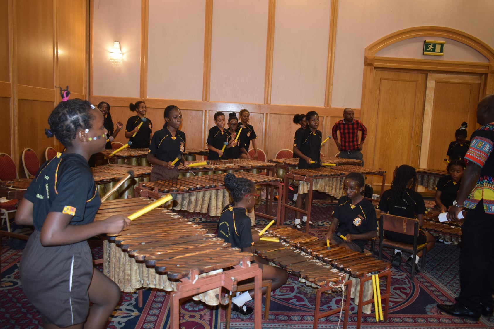 Learners performing together on marimbas