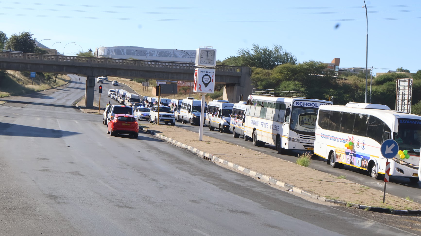 Sunshine school buses travelling together through Windhoek