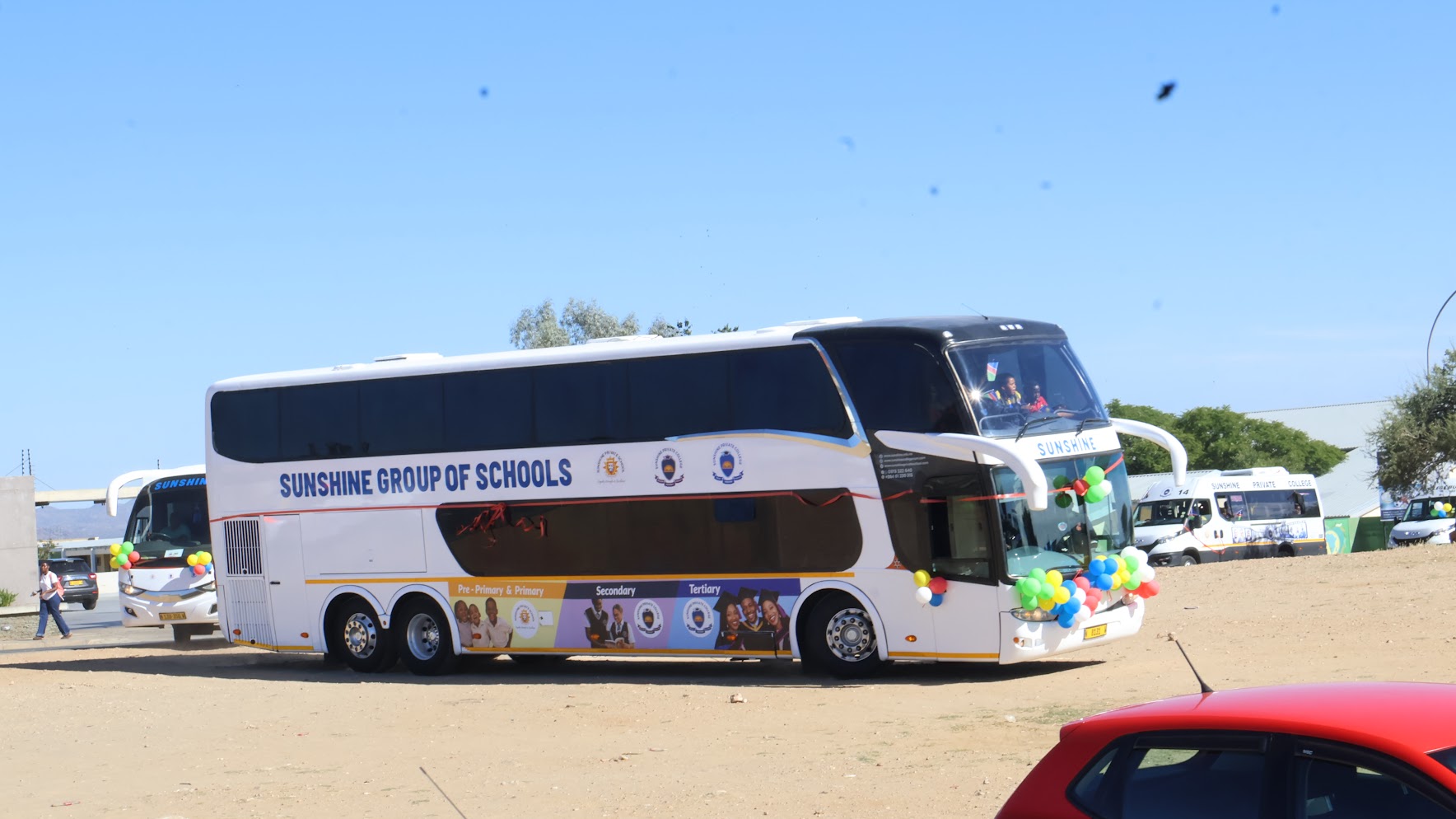 A large Sunshine Group of Schools bus prepared for travel