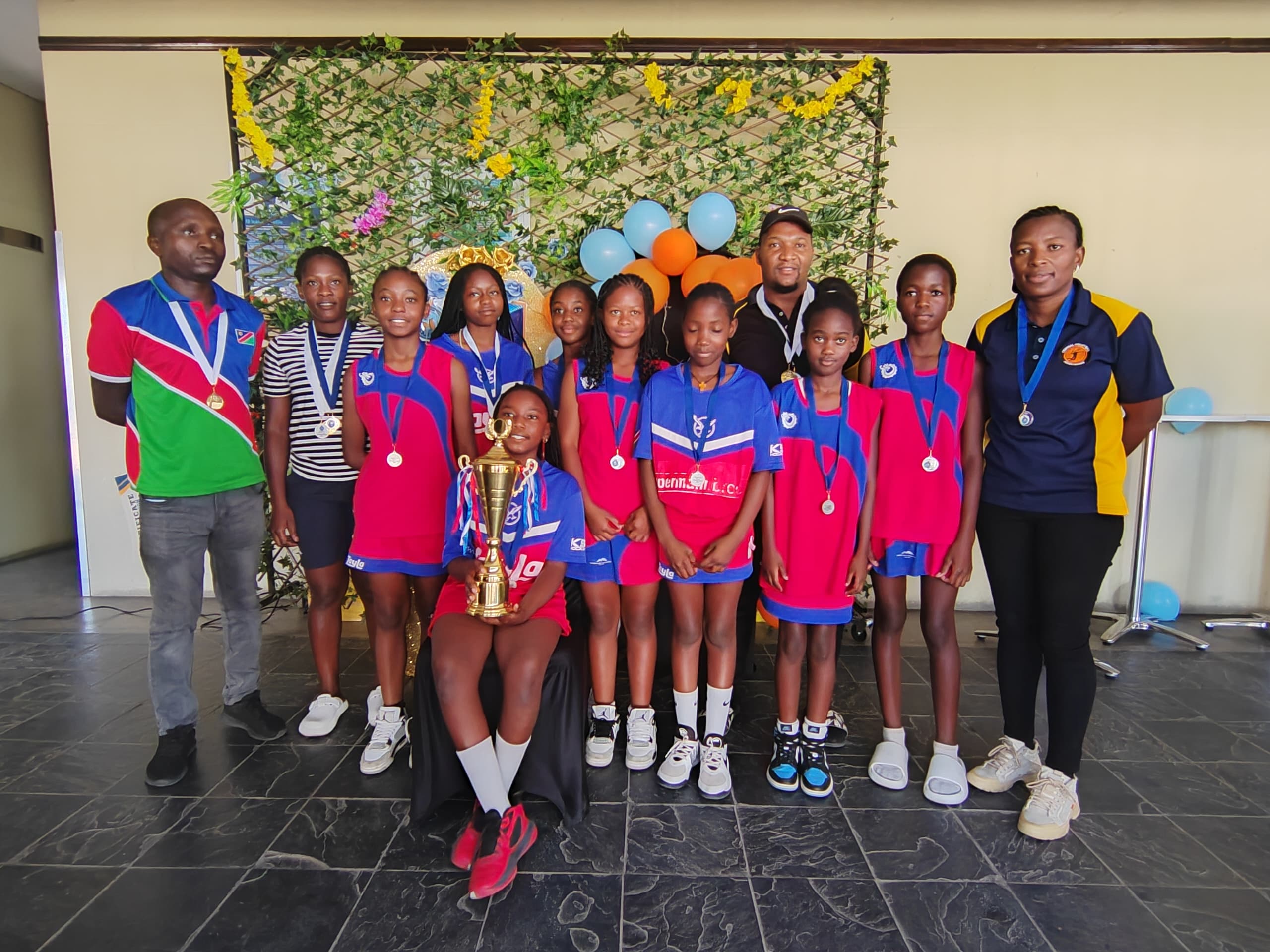 Sunshine netball team with their coaches